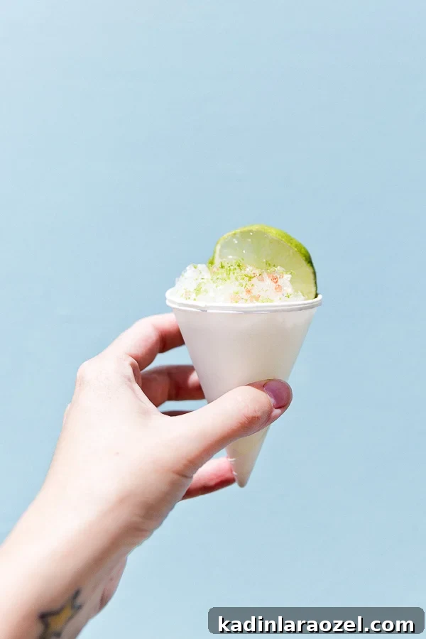 Cone Head Margarita Snow Cones: Frozen Cocktail Shaved Ice 3 woman holding hand out with a spike snow cone in her hand