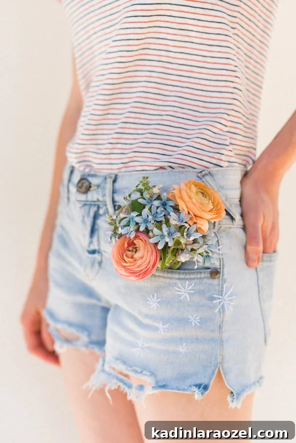 Embroidered jean shorts with flowers in jean pocket.