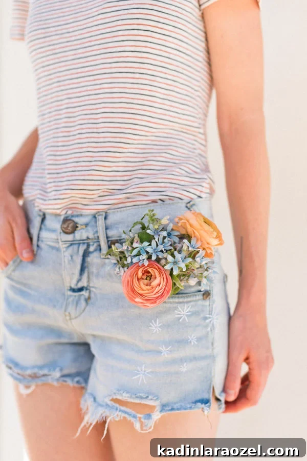 Embroidered jean shorts with striped shirt and summer flowers in jean pocket.