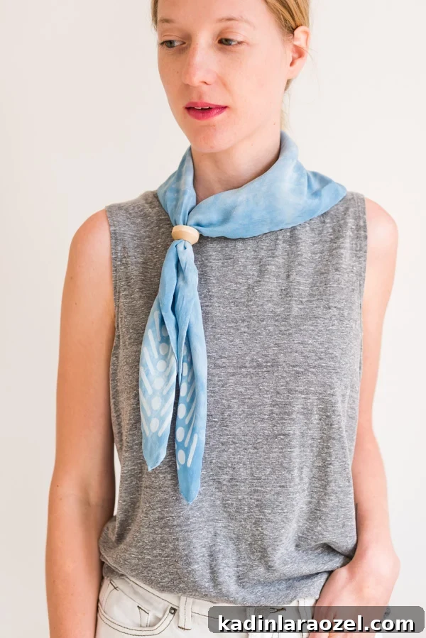 How to style 'the triangle bolo'. Click through for all six ways to style a silk scarf, with step by step photos for recreating each look at home. #scarfstyling #howtostylescarf #silkscarf #fashiondiy #fashionstyling