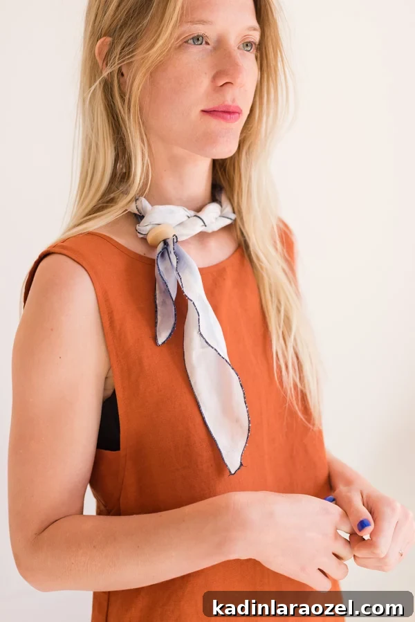 How to style 'the twisted necklace'. Click through for all six ways to style a silk scarf, with step by step photos for recreating each look at home. #scarfstyling #howtostylescarf #silkscarf #fashiondiy #fashionstyling
