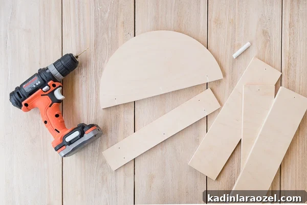 Cut pieces of wood in various shapes, next to a drill