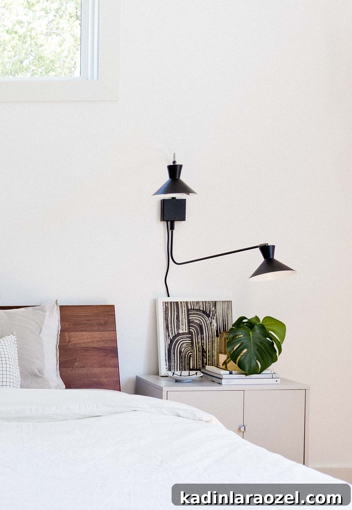 Minimal modern bedroom with white walls and walnut headboard