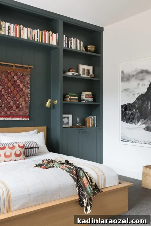 Built in bookcase, painted dark green, surrounding headboard of bed in small modern bedroom