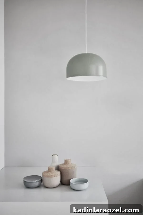 All grey room with modern pendant light shaped like an upside-down bowl