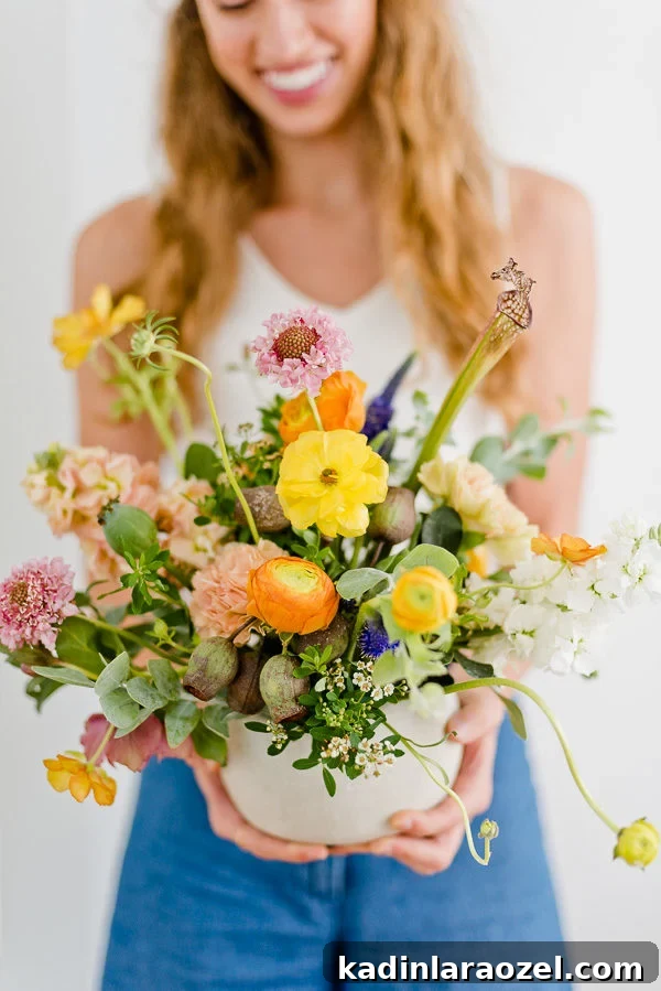 Flower Arranging Tips from a Florist: 8 Simple Tricks & A Signature Bouquet Recipe 2 woman holding floral arrangement with wild and organic looking flowers