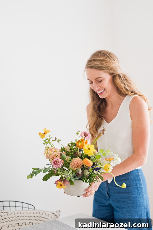 Flower Arranging Tips from a Florist: 8 Simple Tricks & A Signature Bouquet Recipe 3 woman holding floral arrangement to set on a table for a dinner party