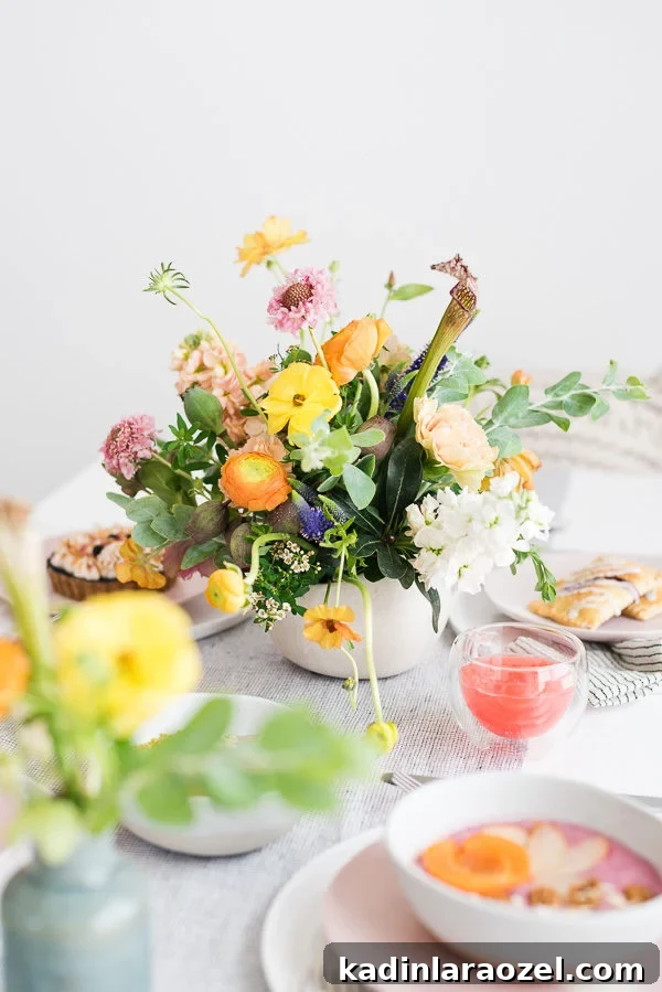 Host a Chic Brunch with Friends: Simple Stylish Ideas 8 That centerpiece! #flowerpower #floralinspiration #brunchflorals #brunchinspiration #summerentertaining #pastelvibes #brunch
