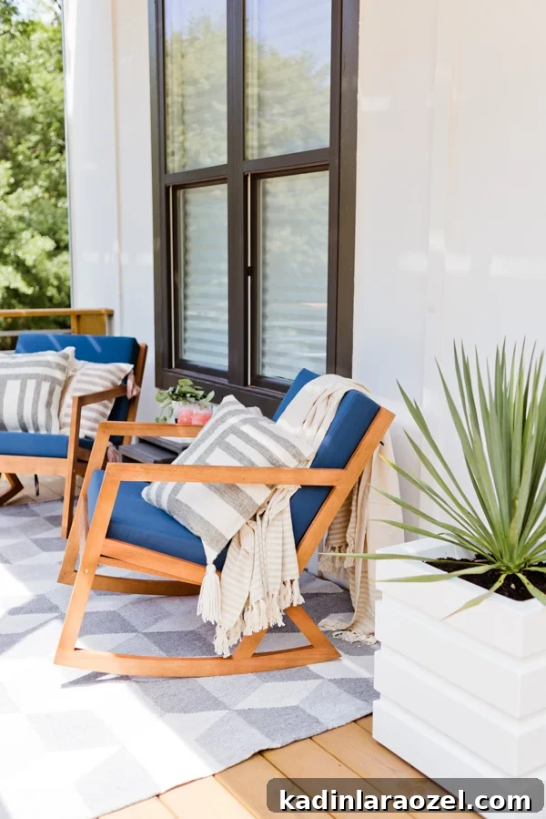 See the full reveal of a small outdoor space that went from completely bare to cozy and comfortable with just a few items. #frontporchreveal #outdoorreveal #outdoormakeover #frontporchmakeover #beforeafterhome #porchmakeover