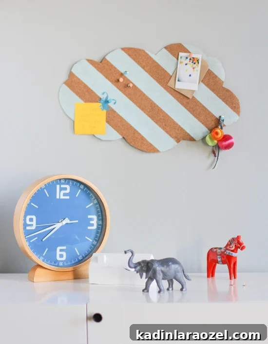 cloud shaped cork board with painted stripes, hanging on wall in kids room