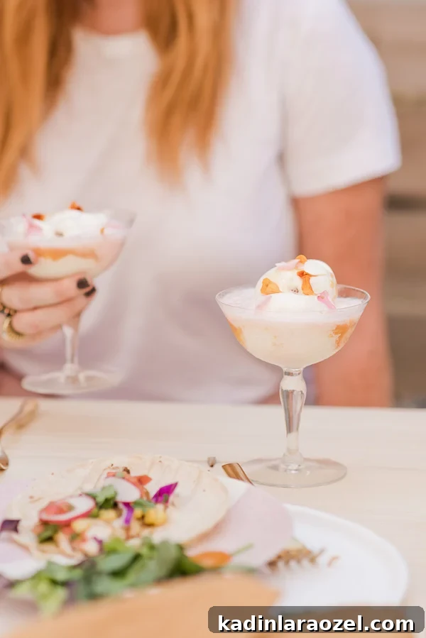 Make these peaches and cream soda floats (with edible flower petals) for summer entertaining. Click through for more entertaining tips and recipes from Brittni Mehlhoff of Paper and Stitch. #summerentertaining #entertainingideas #entertainingtips #dinnerparty #outdoorentertaining #icecream #sodafloat #dessertideas #summerdessertideas #weddingdesserts