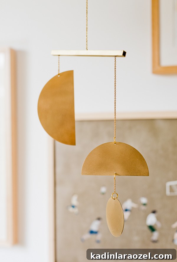 12 Rooms in 12 Months: Hayes’ Nursery Reveal 15 A brass mobile for a little boy's gender neutral nursery.