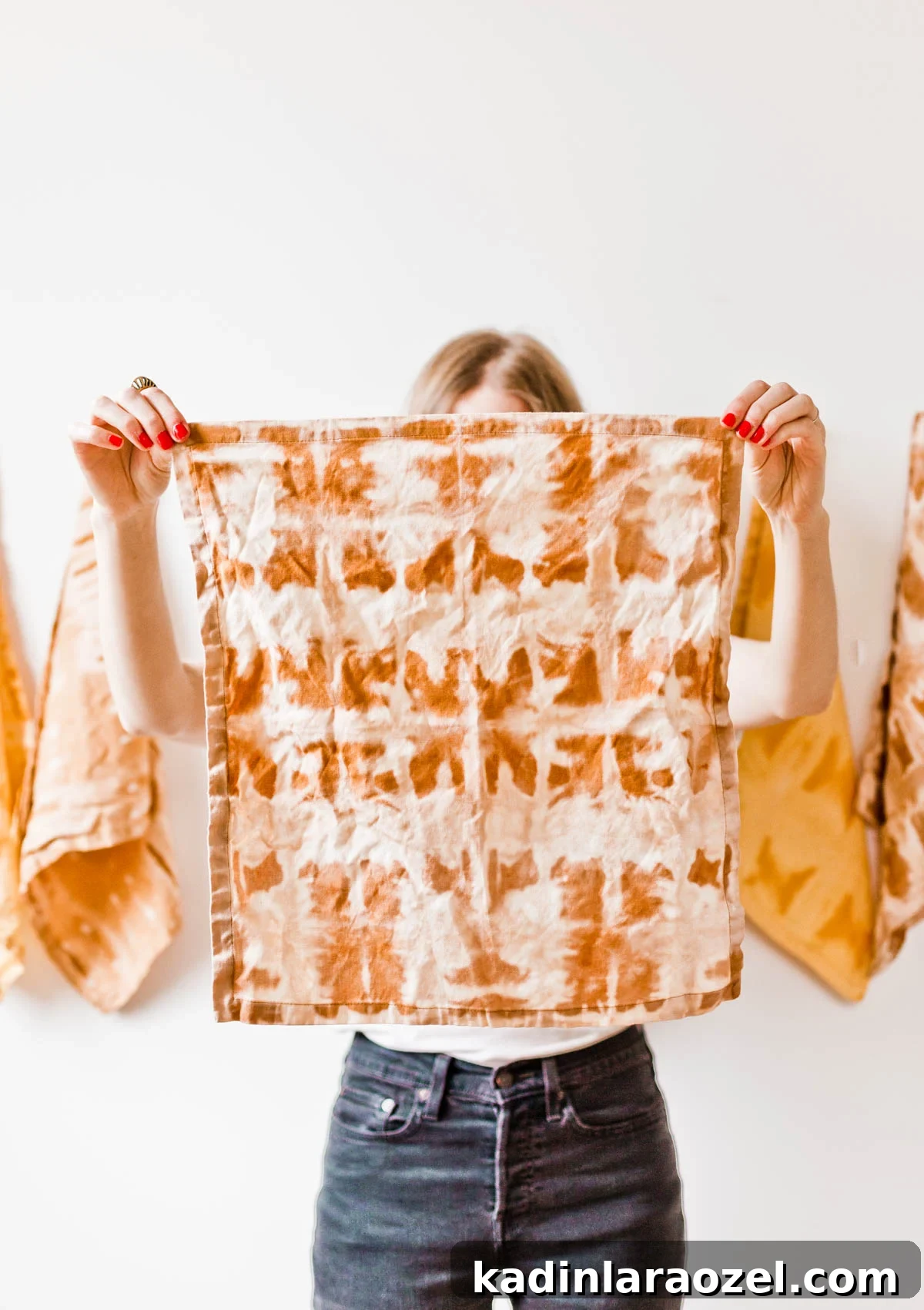 Woman holding reverse tie dye print napkin in front of her