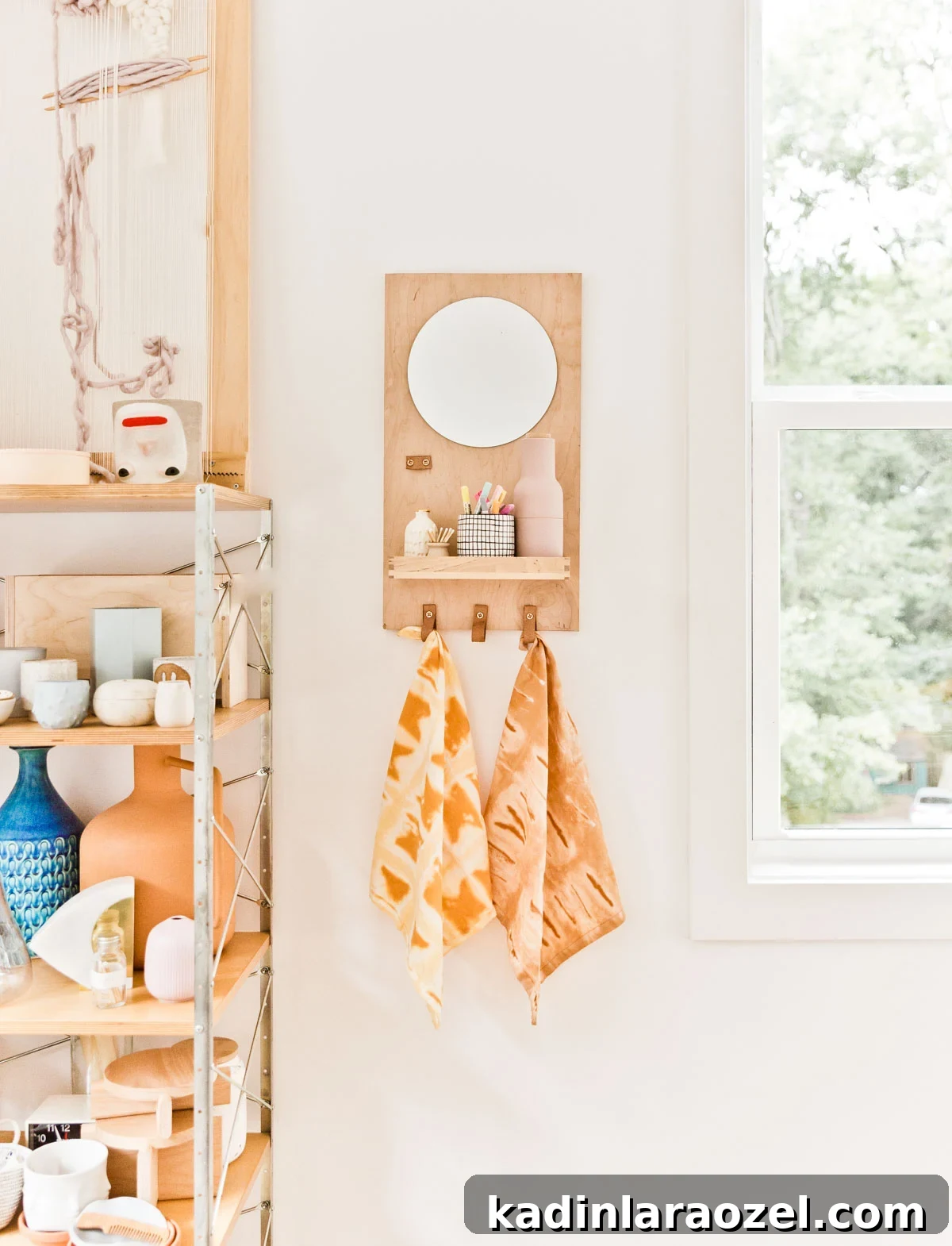 Tie dye DIY textile project, hanging from a wood shelf in a modern craft room