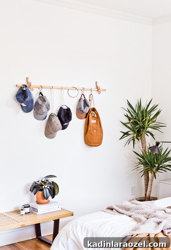 Organic modern bedroom with white walls and unique rail wall organizer, with hanging hats and bags
