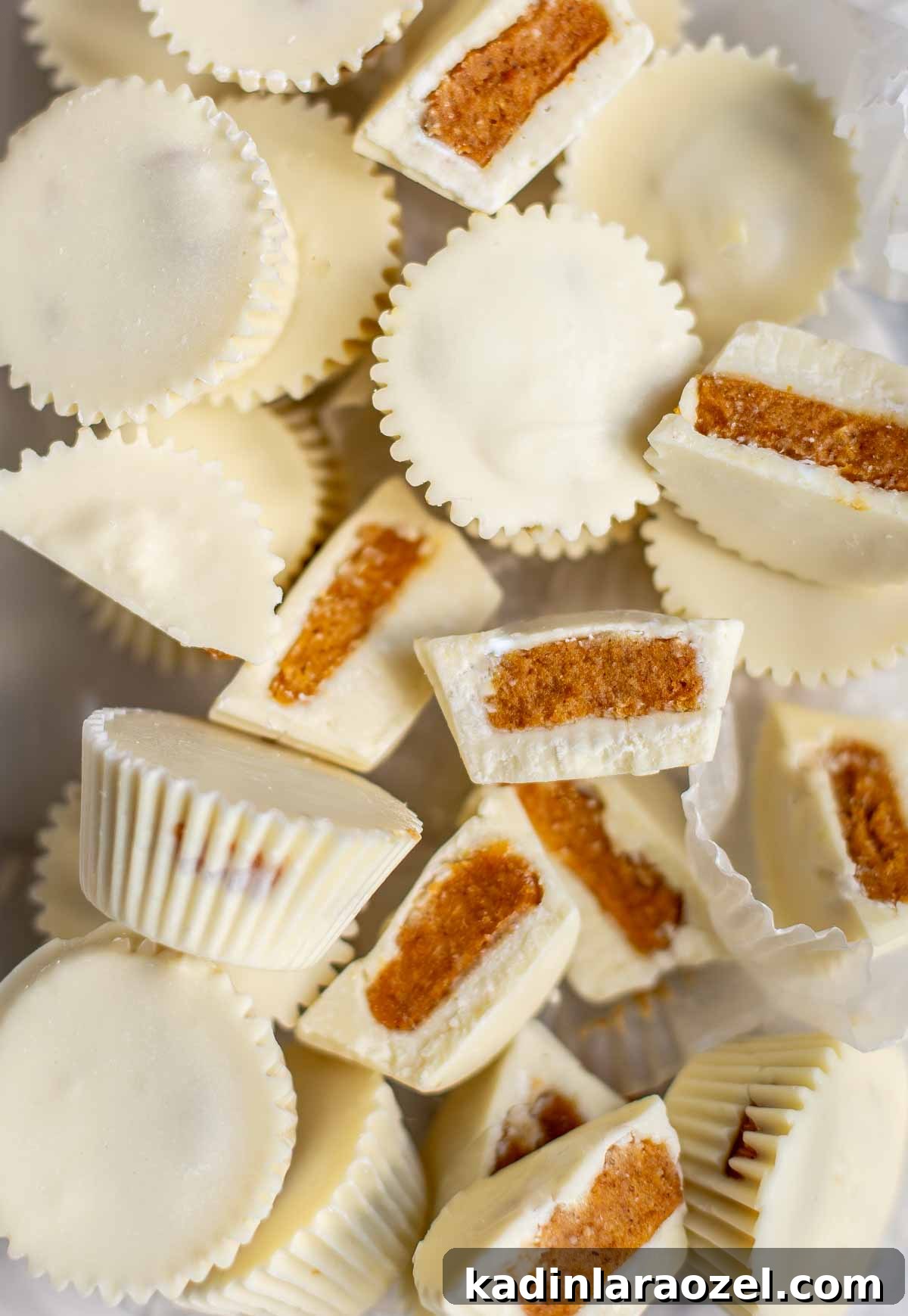 pile of white chocolate pumpkin pie candy cups overhead and broken into pieces