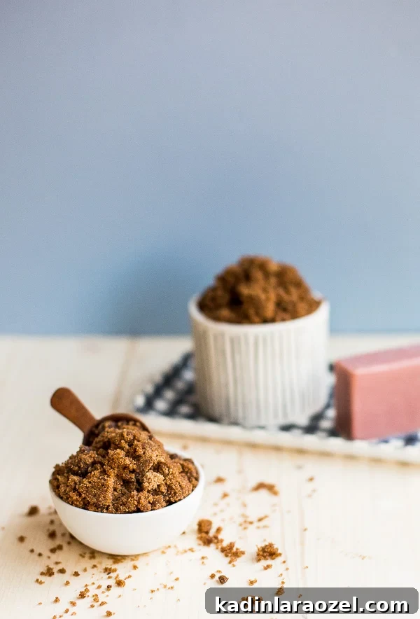brown sugar scrub in two small bowls, with a wooden stopper in one, overflowing with sugar scrub