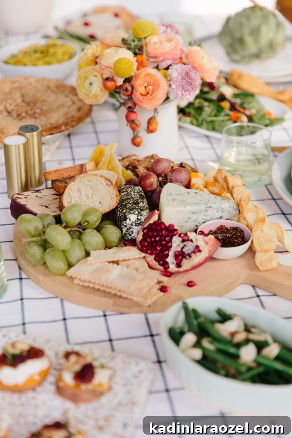 Upgrade Your Thanksgiving Tablescape in 15 Minutes: 3 Simple Ideas 5 wood cutting board centerpiece for Thanksgiving, filled with cheese, bread, crackers, fruit, and more