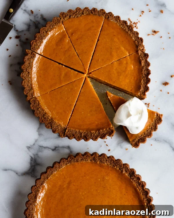 11 Irresistible Fall Recipes You’ll Crave This Season 6 Pumpkin pie cut into slices with gingerbread crust! and a dollop of whipped cream on one of the slices