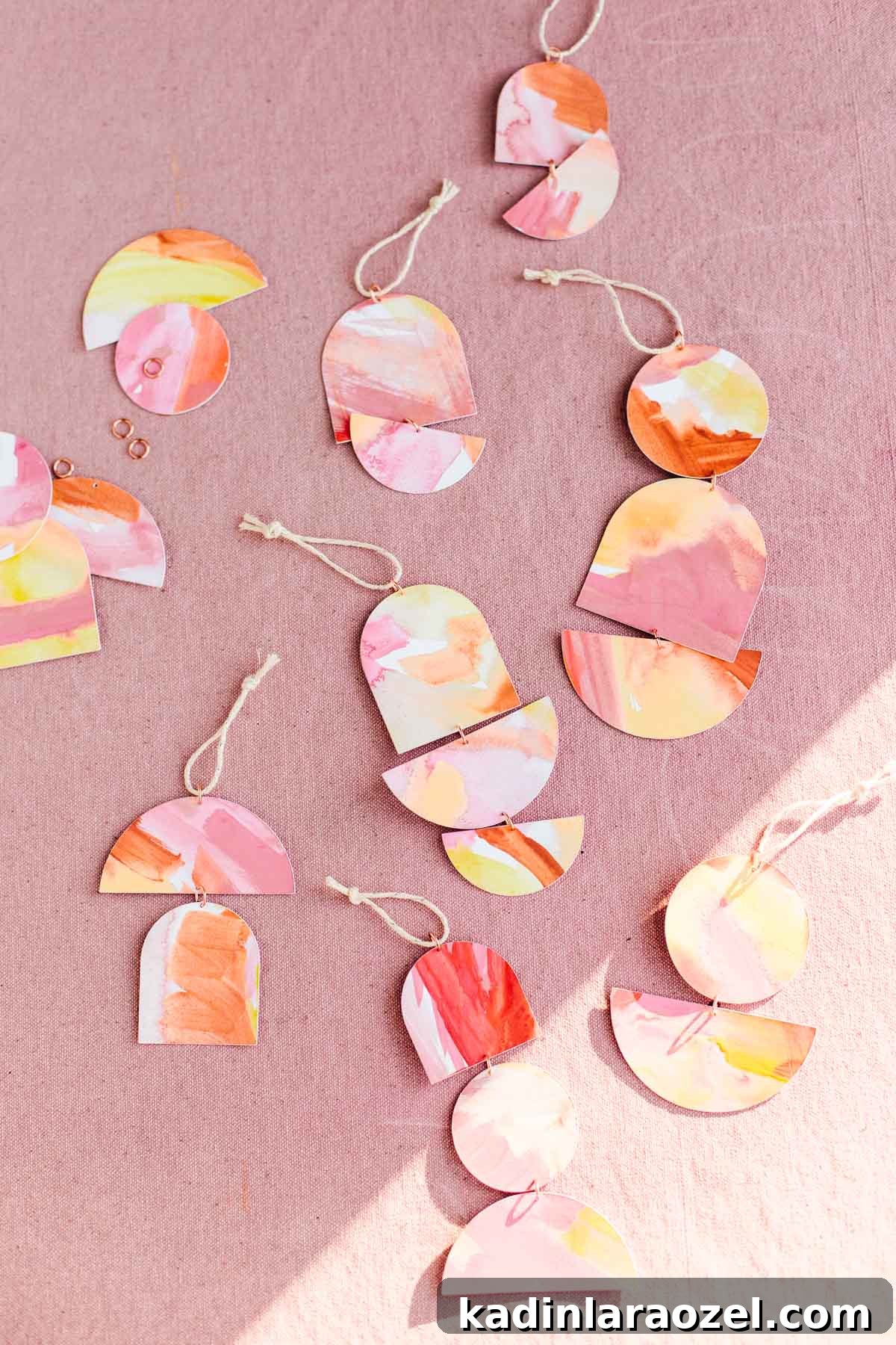 Paper ornaments in geometric shapes attached with jump rings