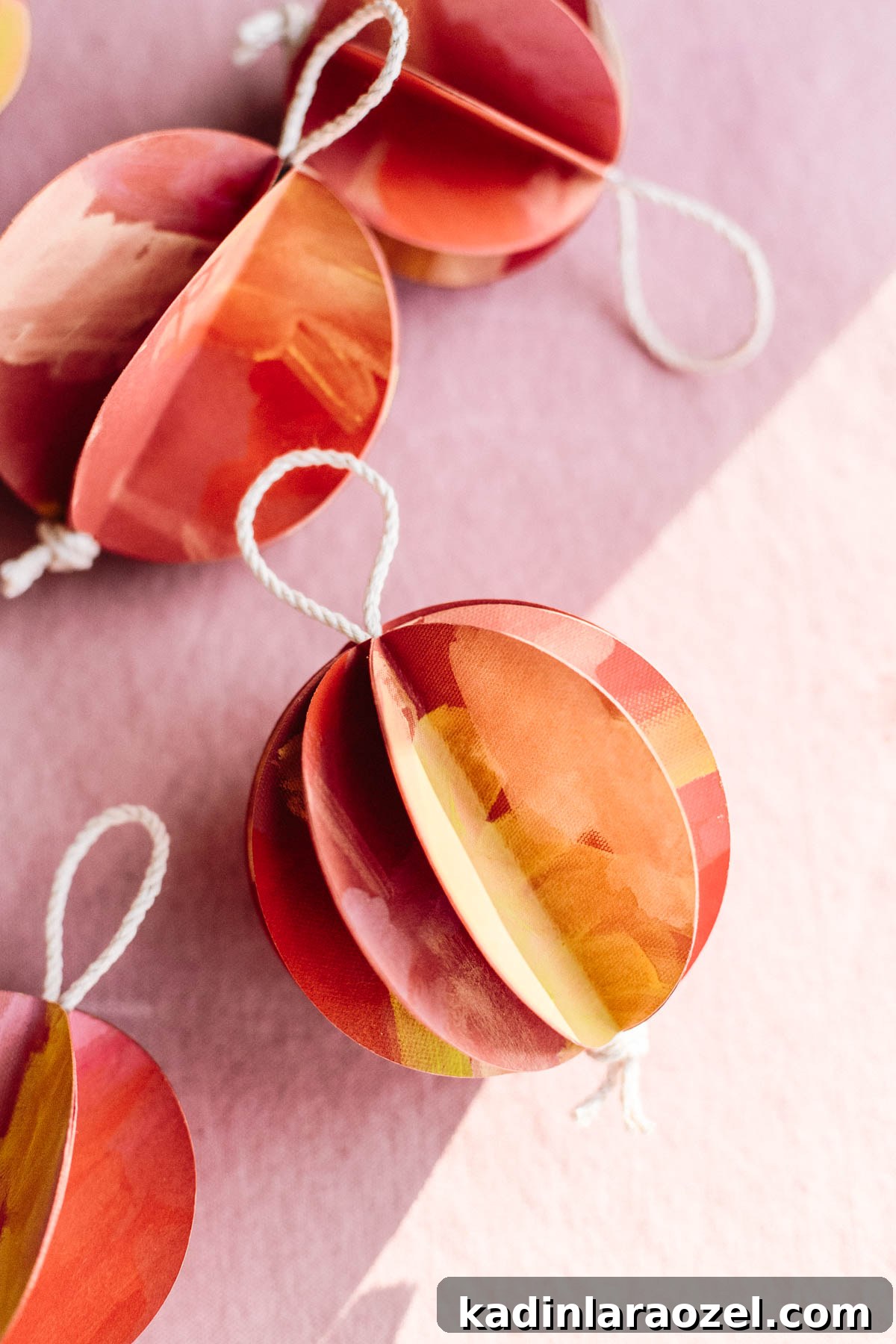 Three-dimensional ball ornaments made of painted paper in warm colors