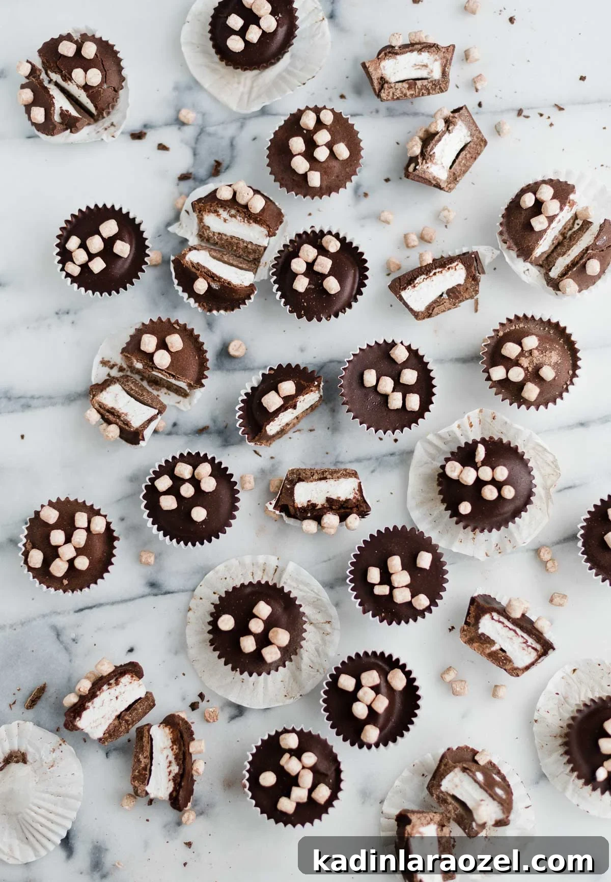 chocolate candy cups with marshmallow on a marble counter