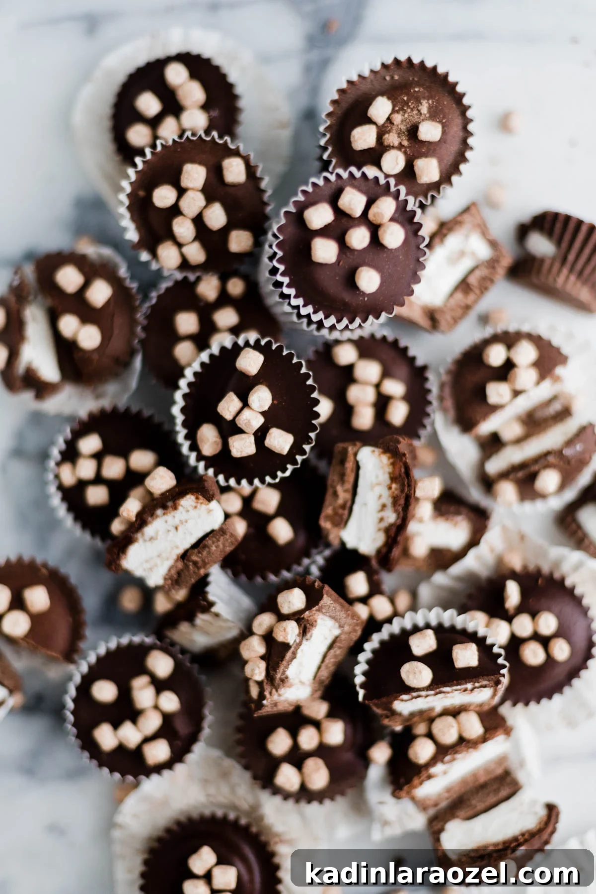 closeup stack of chocolate candy cups with tiny marshmallows on top