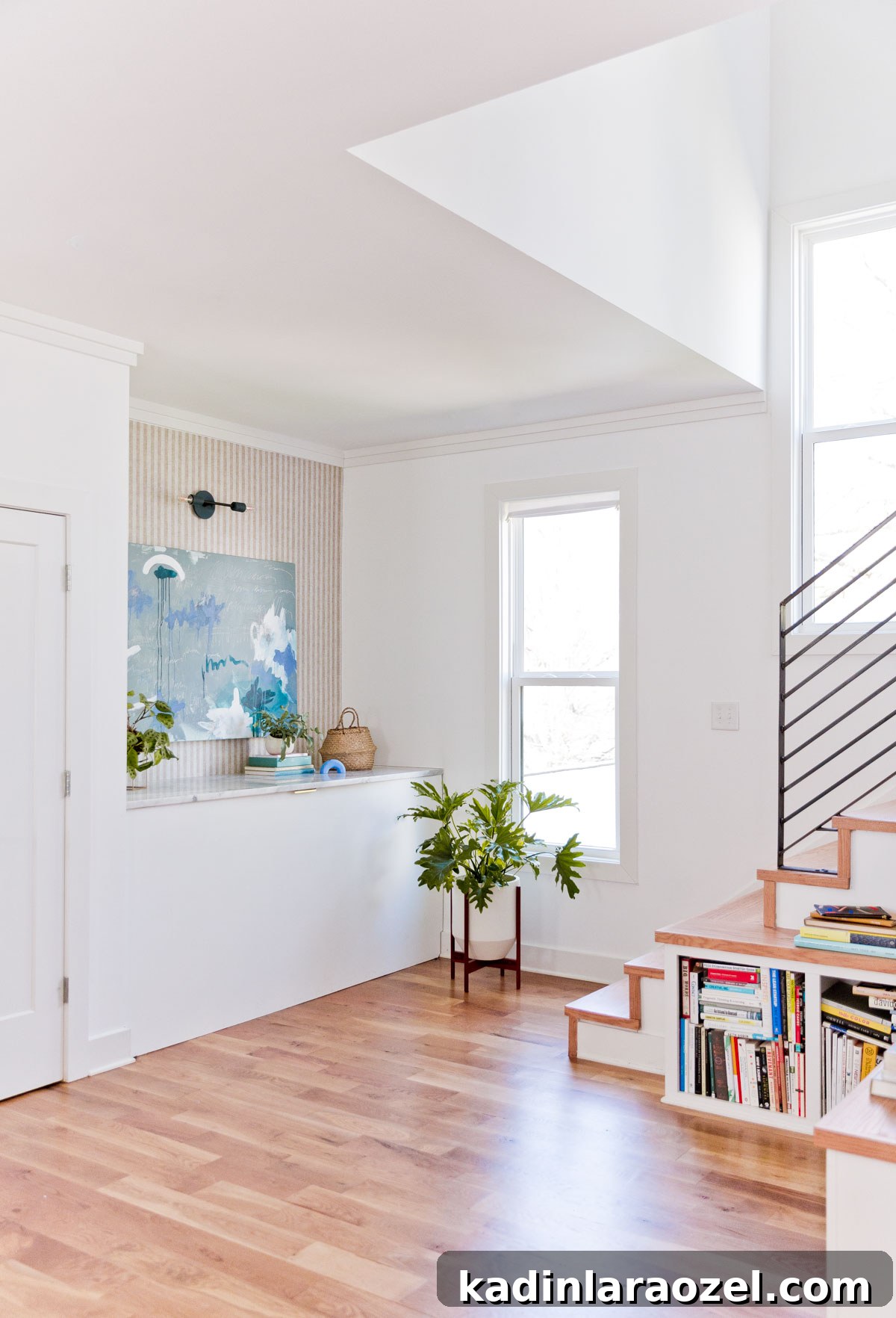 From Farmhouse Drab to Modern Chic: Transforming an Awkward Landing for Under $450 10 Minimal modern landing area with striped wallpaper, white walls, and abstract artwork