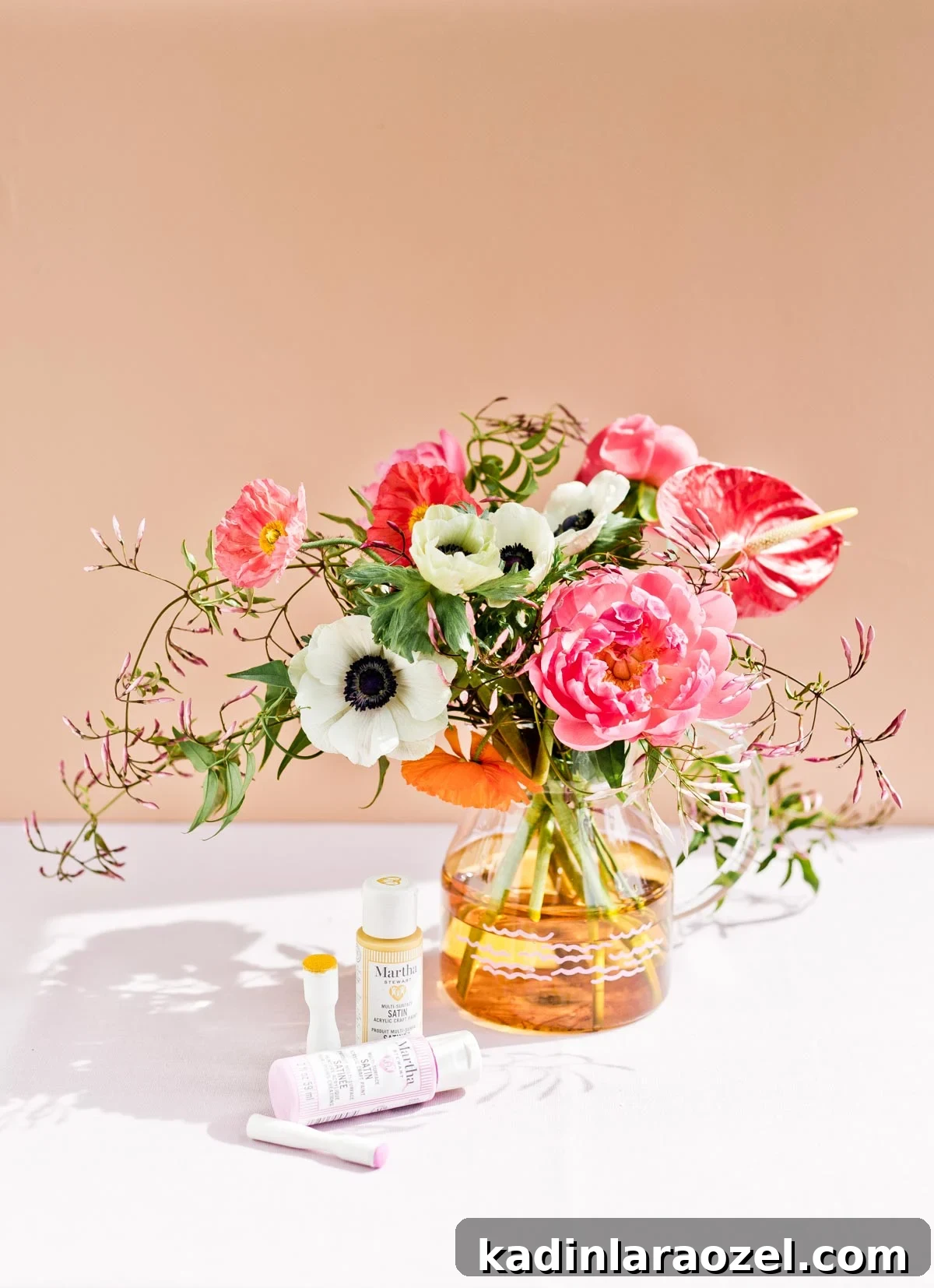 Simple glass vase with peonies and anemones bouquet