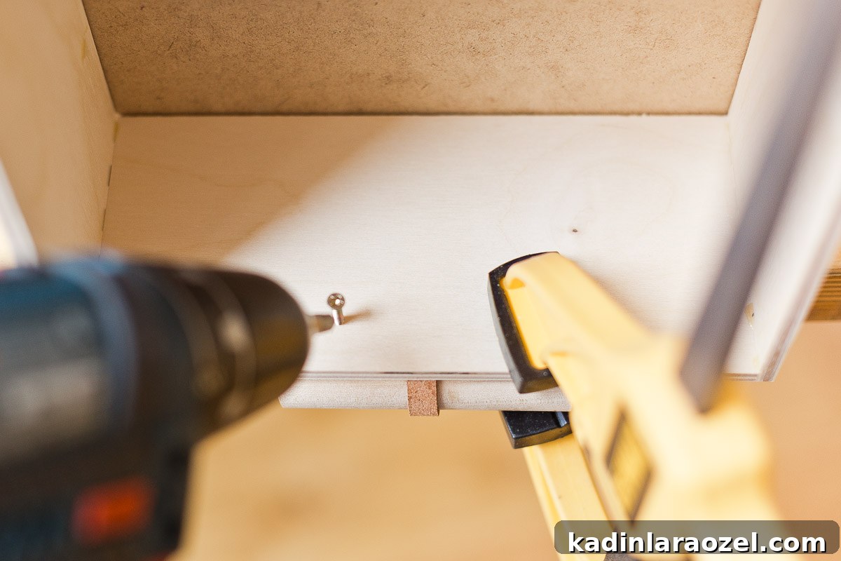 Transform Your Ikea Moppe Mini Chest with a Modern Minimal Hack 8 Screwing DIY drawer pulls into drawer.