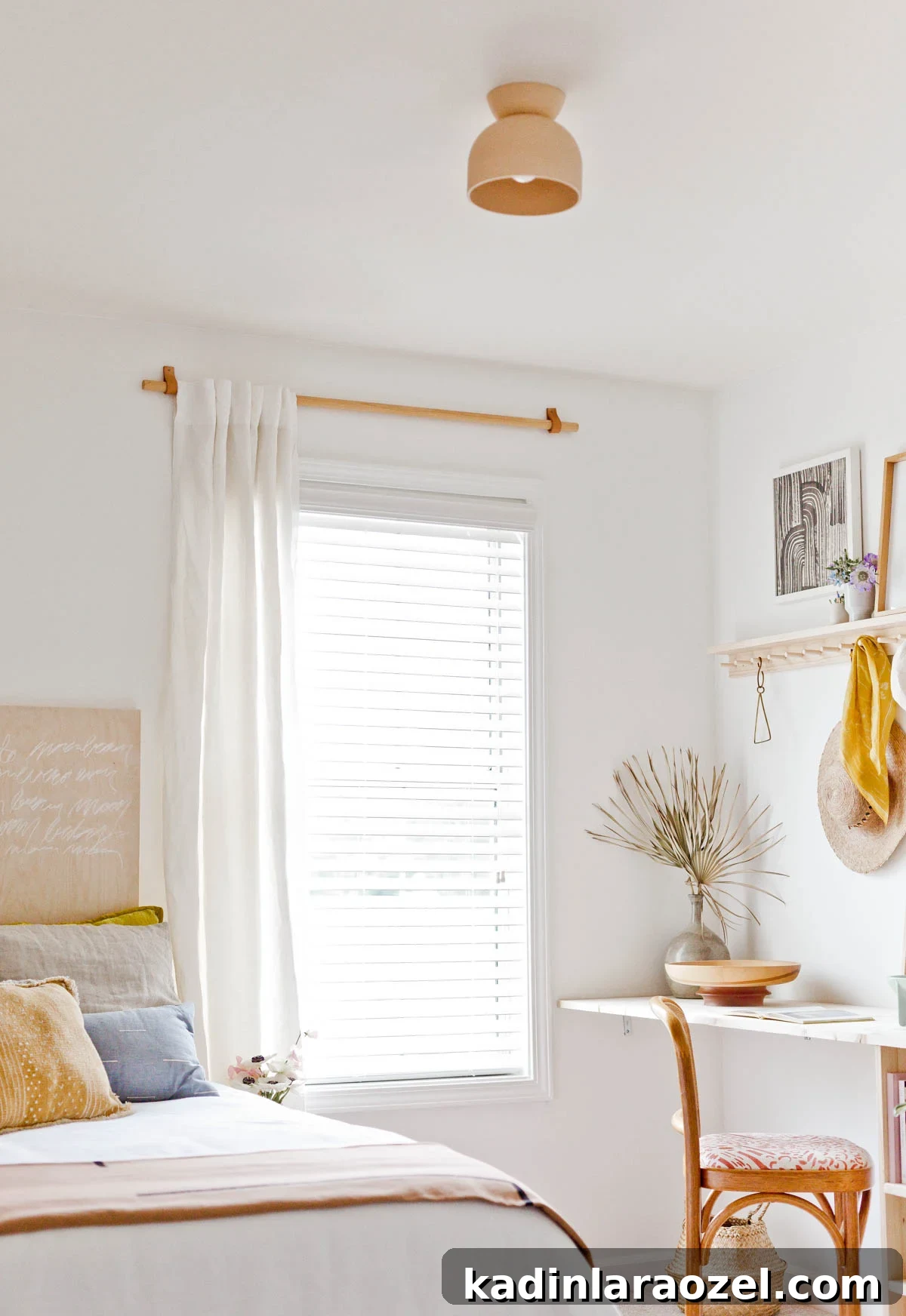 Earthy, minimal bedroom that has a built in wood desk and organizational peg rail 