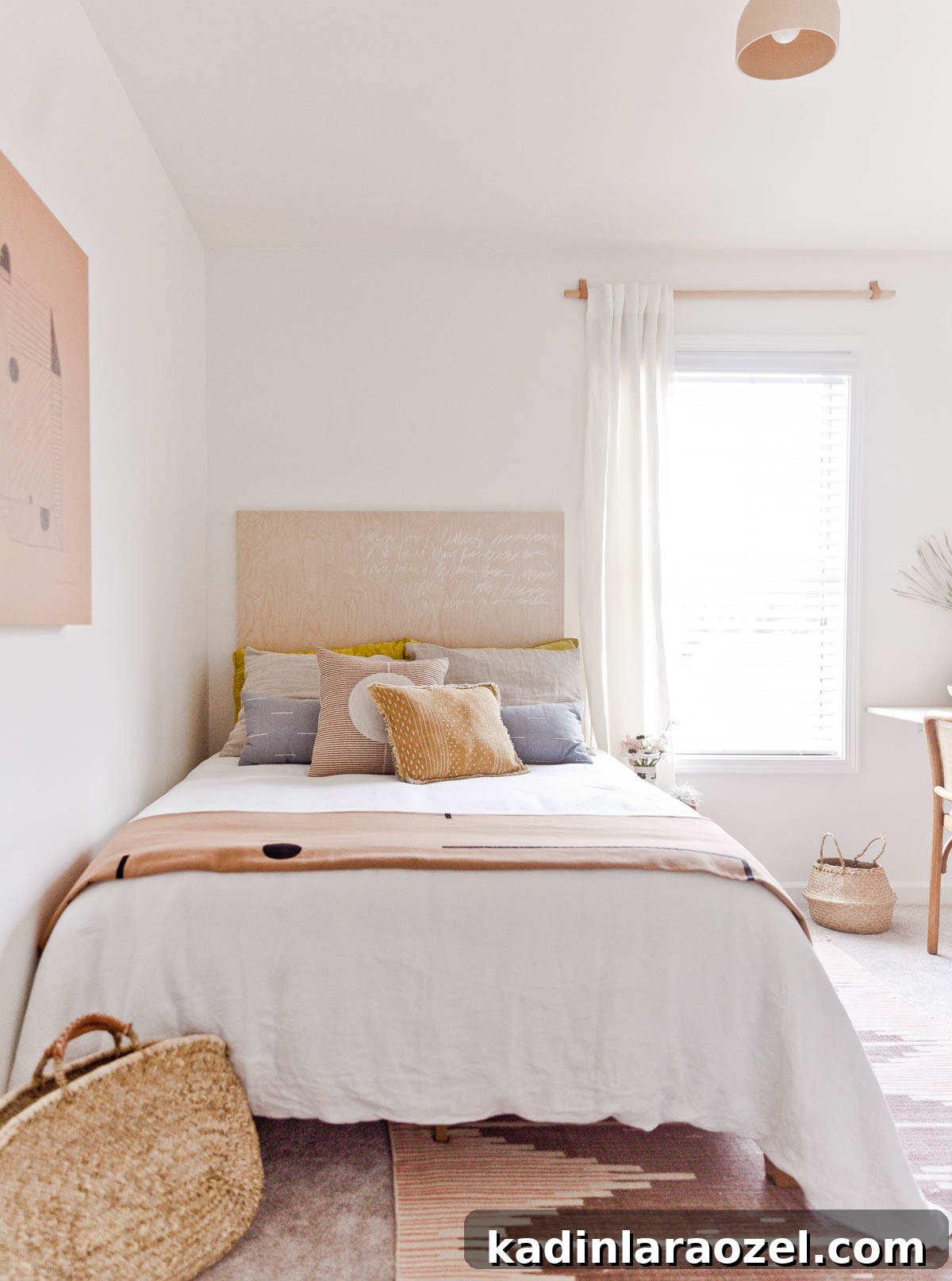 Bed with white linen bedding, birch wood headboard, and pink geometric rug
