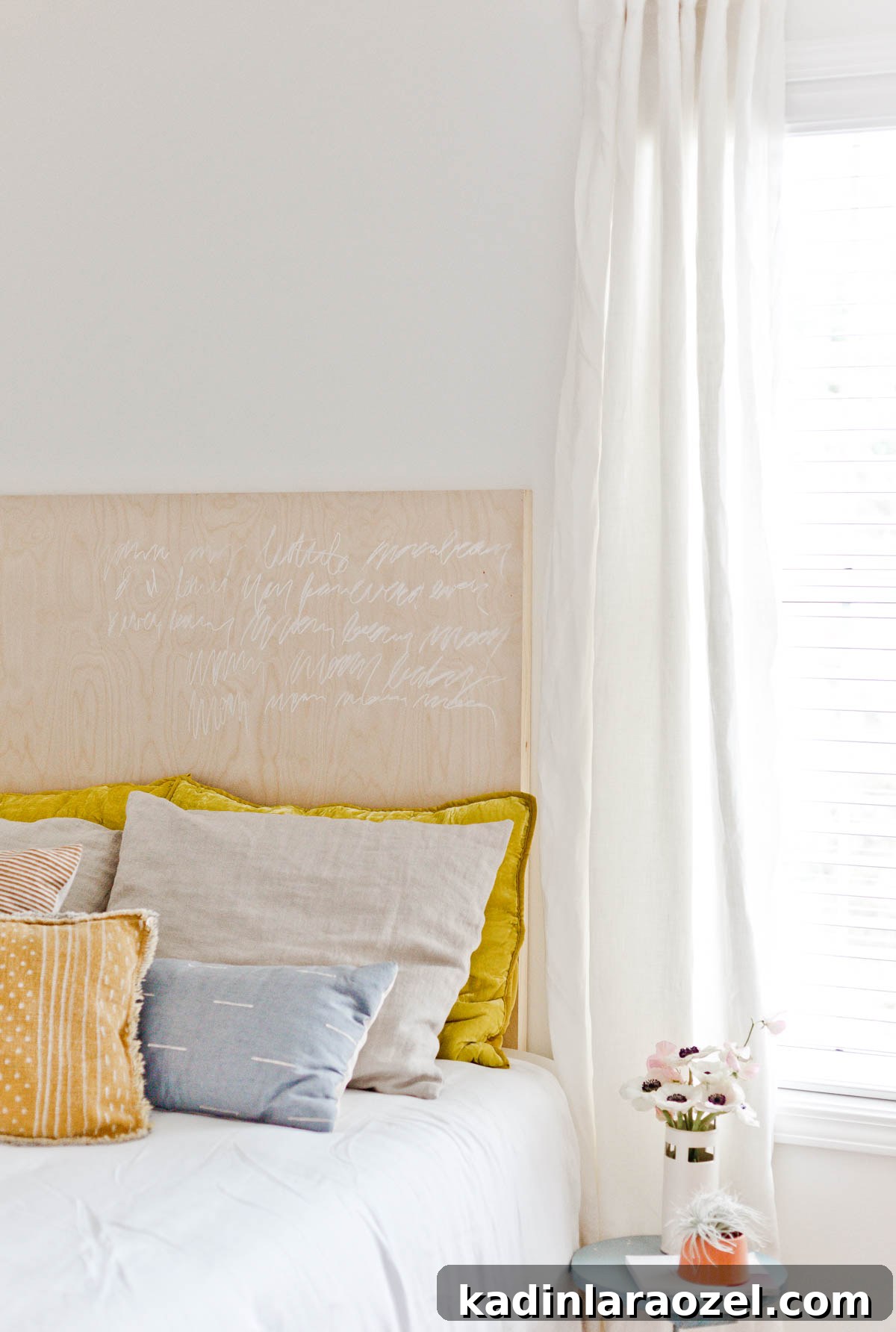 Cosy bed with lots of pillows and white bedding