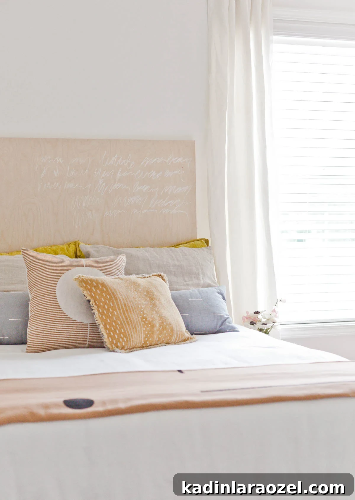 Neutral earthy bedroom details, with textured pillows and simple white bedding