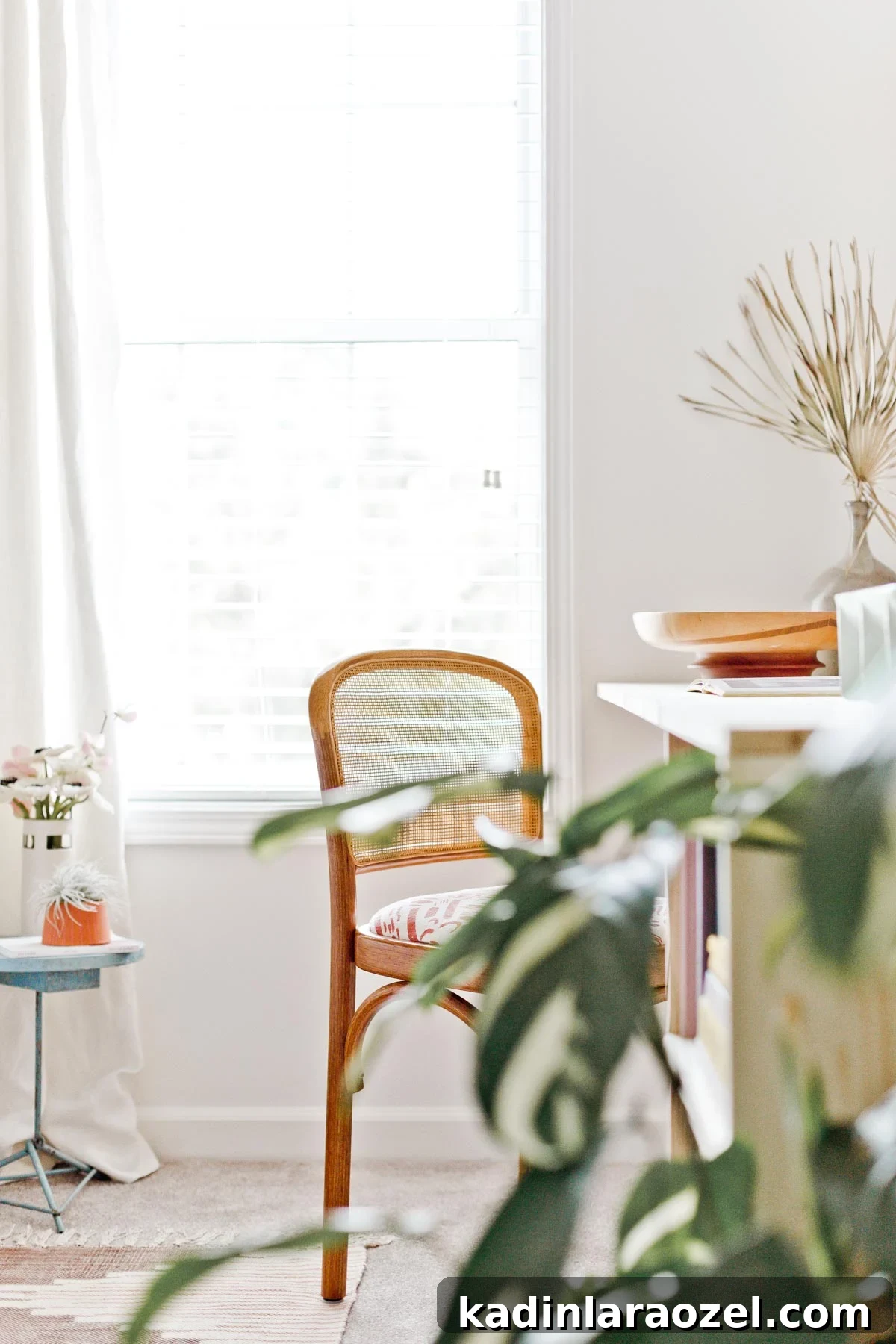 Guest bedroom with white walls and simple wooden desk that is built in to the wall