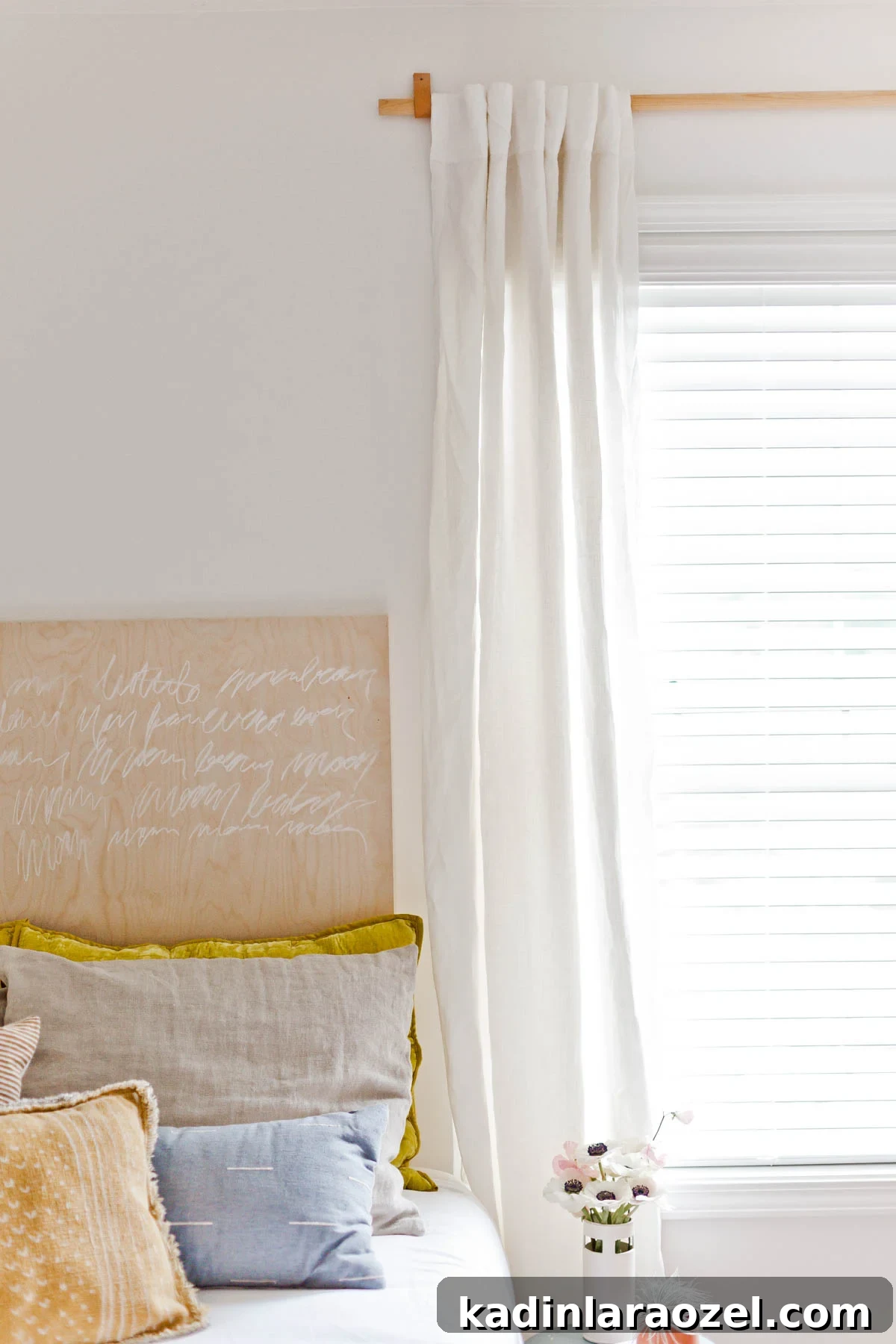 DIY Curtain Rods for Under $10: A Step-by-Step Guide 5 white and neutral bedroom with modern wood curtain rod hanging from window.