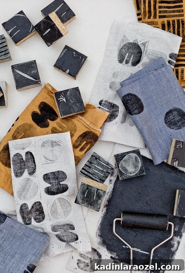 Block Printing Basics: A Step-by-Step Guide to Printing Fabric 12 Overhead photo of pattern block printed fabric and carved linoleum blocks all around it.