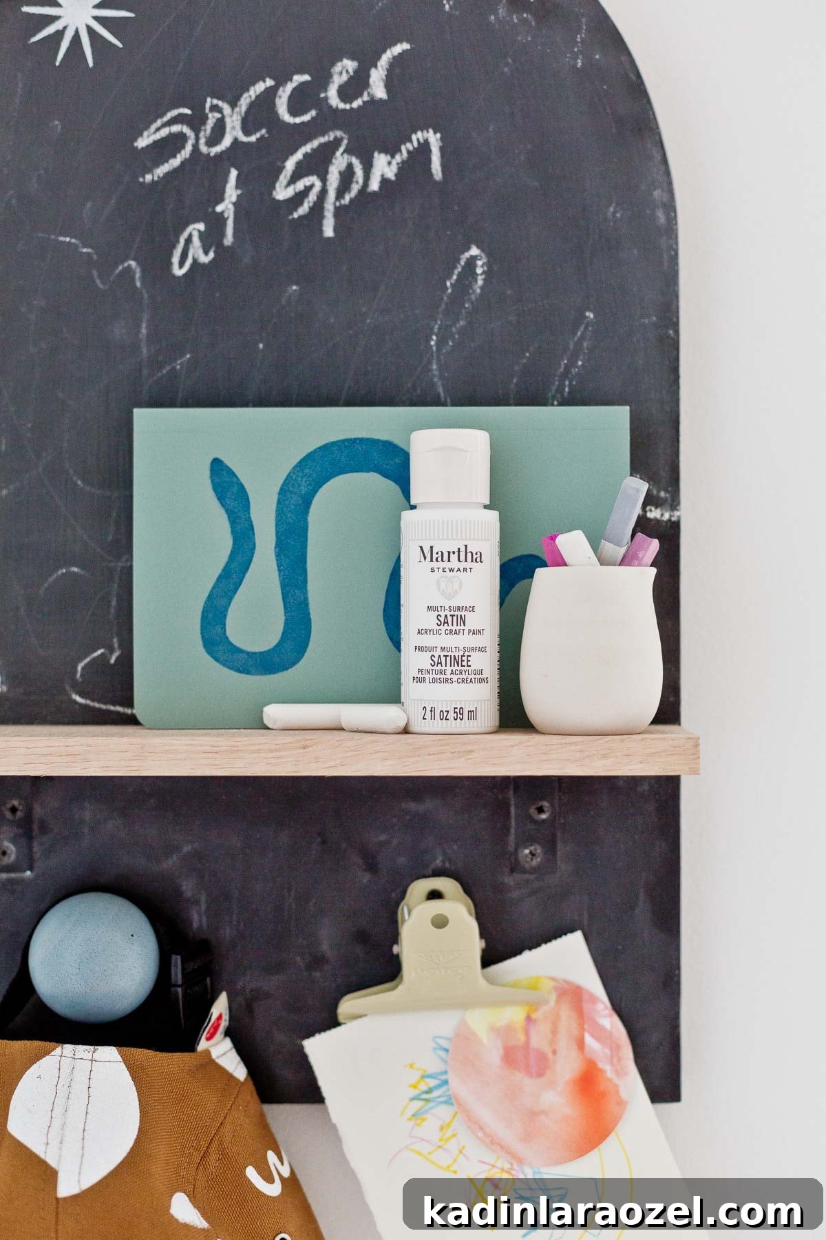 3 Stylish Back-to-School DIY Projects That Impress 7 Black arch chalkboard DIY with wooden shelf and hooks at the bottom for hats and artwork