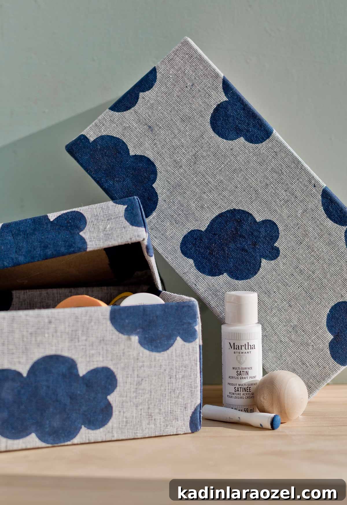 3 Stylish Back-to-School DIY Projects That Impress 10 Fabric covered storage boxes on wood tabletop surface with paint and stencil materials nearby