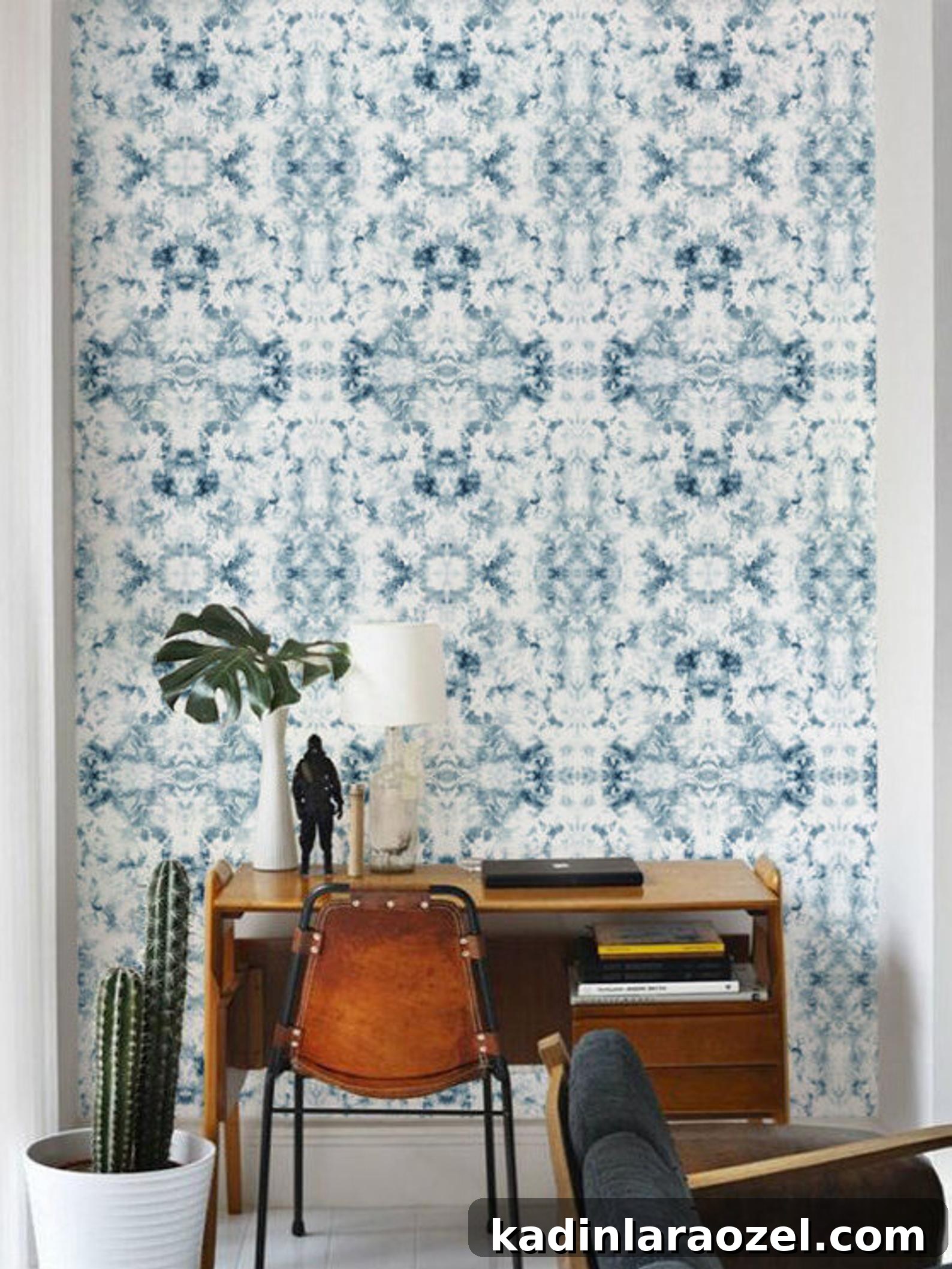 16 Stylish Temporary and Permanent Wallpapers to Transform Your Home 2 Abstract blue and white pattern wallpaper in a mid-century inspired room.