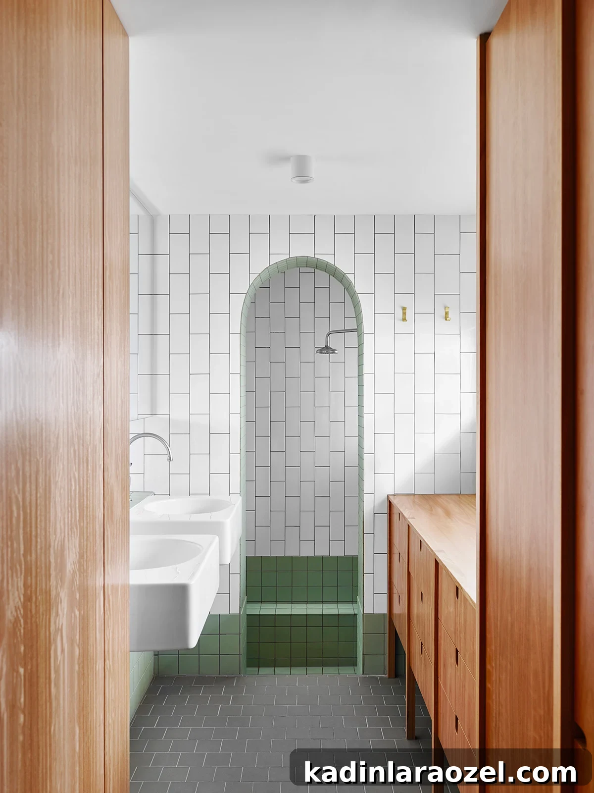 I love how this bathroom from Owen Architecture brings a lot of attention to the arch way by using squared tiles and sharp edges everywhere else. #arch #designtrend #interiors #organicmodern #bathroom #tilebathroom #archdoorway