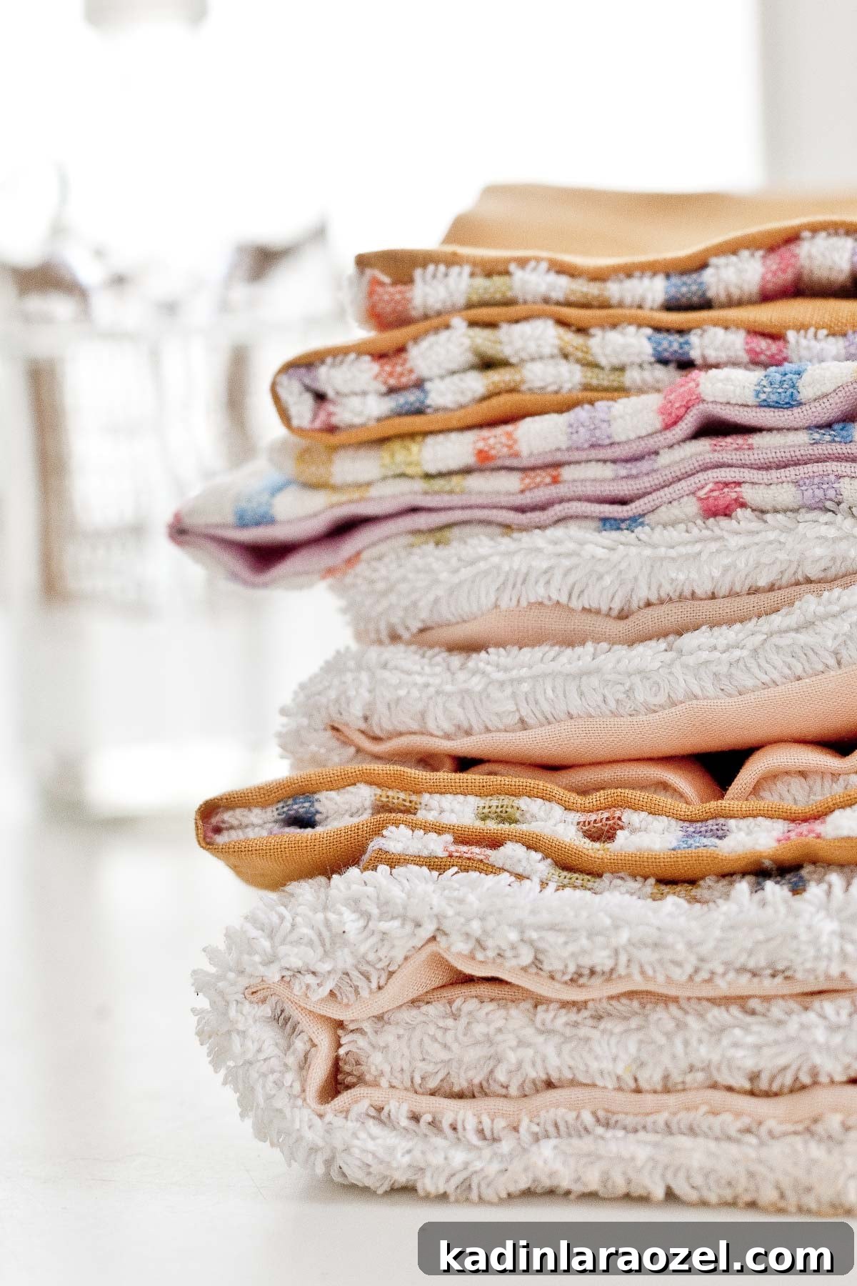 Reusable Unpaper Towels: 2 Ways to Make Cloth Paper Towels from Scraps 7 Stacked DIY unpaper towels using colorful fabric scraps and terrycloth.