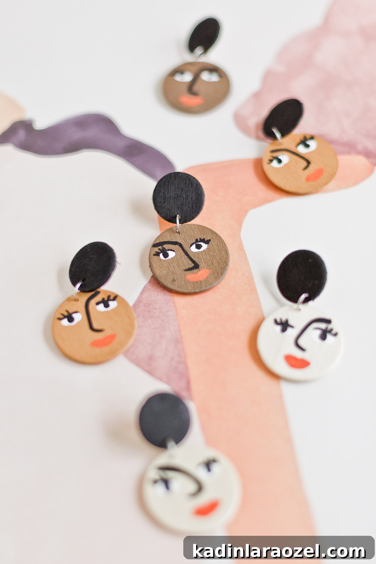 DIY face earrings made with acrylic paint and wood rounds.