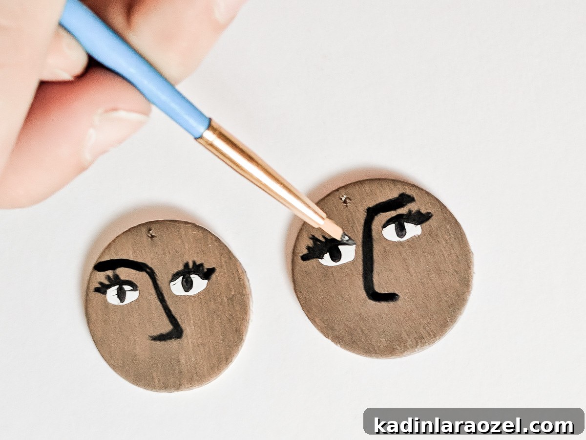 Paint the background of each circle then fill in with face details.