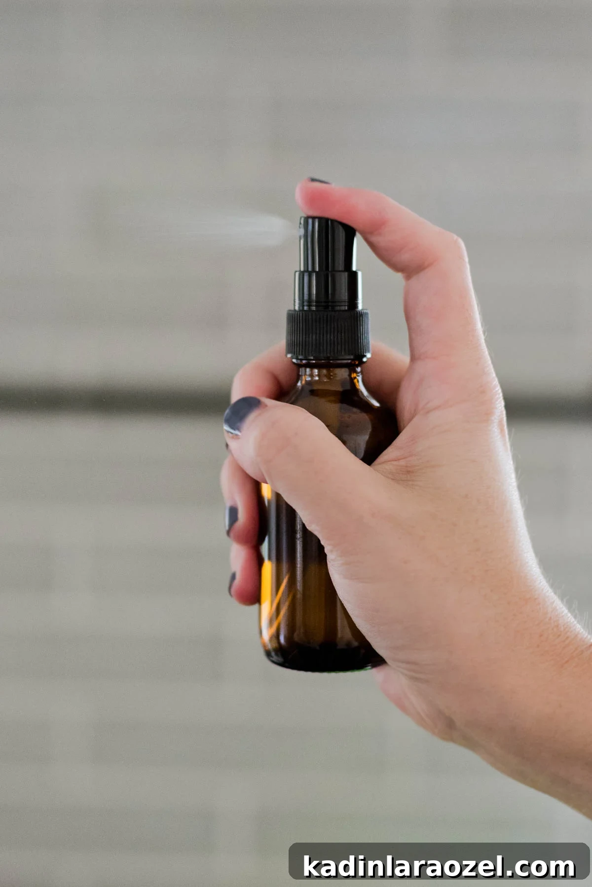 3 DIY Natural Cleaning Recipes You Can Make at Home Today 4 Natural homemade room spray in an amber bottle being sprayed.
