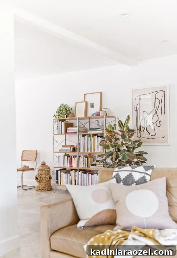 mid-century book shelf with books and decorative objects in a neutral living room