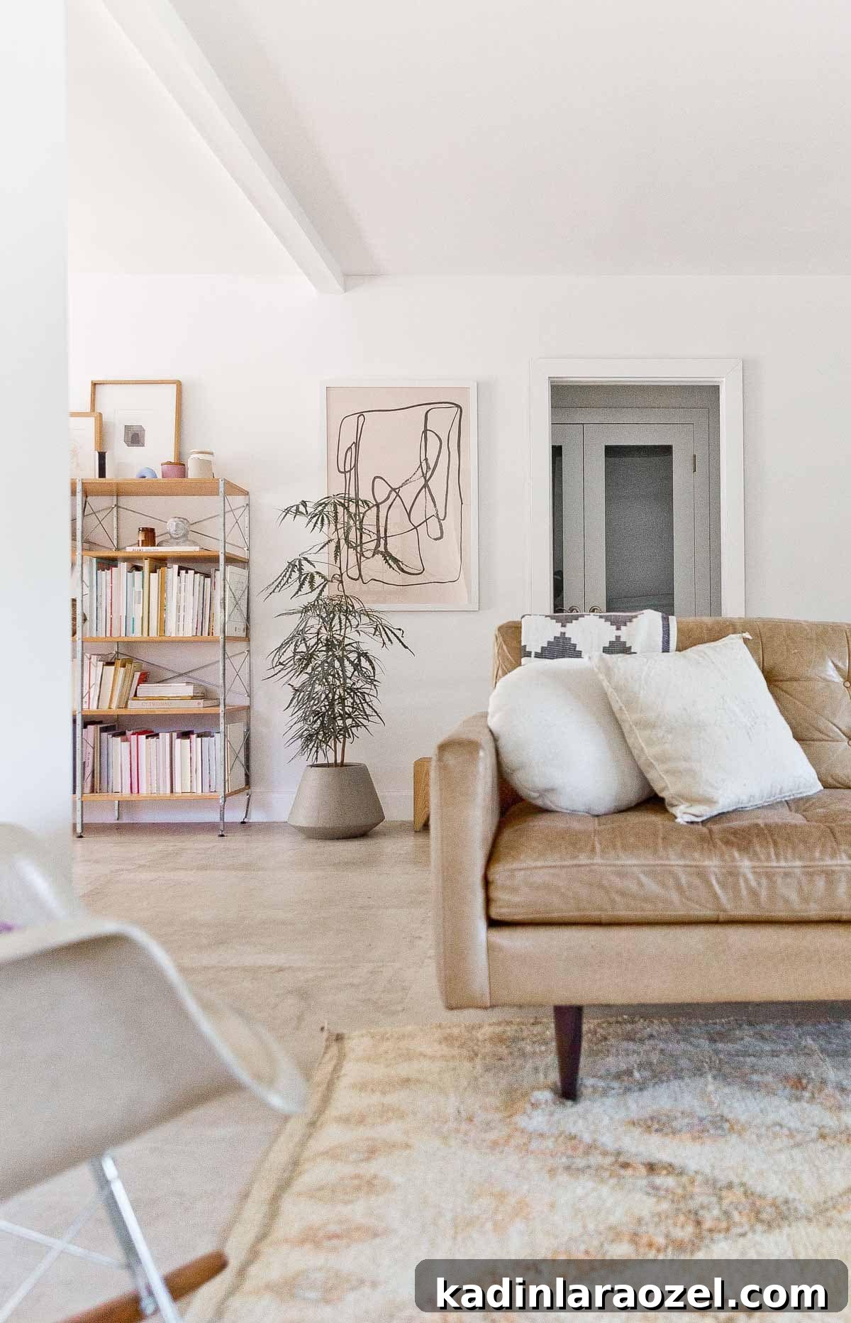 white, modern living room with mid century bookcase styled