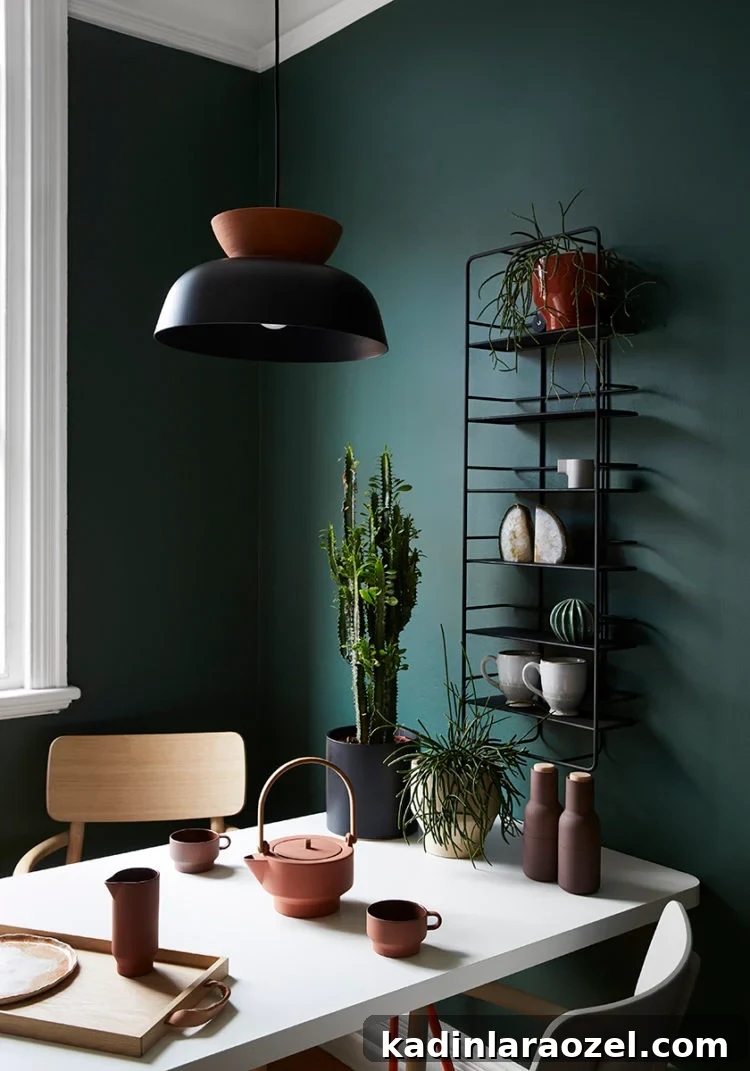 Moody Green Interiors: 12 Stylish Ways to Use the Color 11 Moody green walls in a cozy dining room.