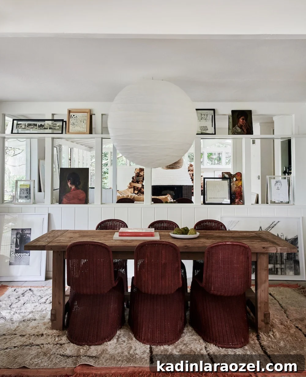 eclectic dining room with rustic table and dark red painted chairs