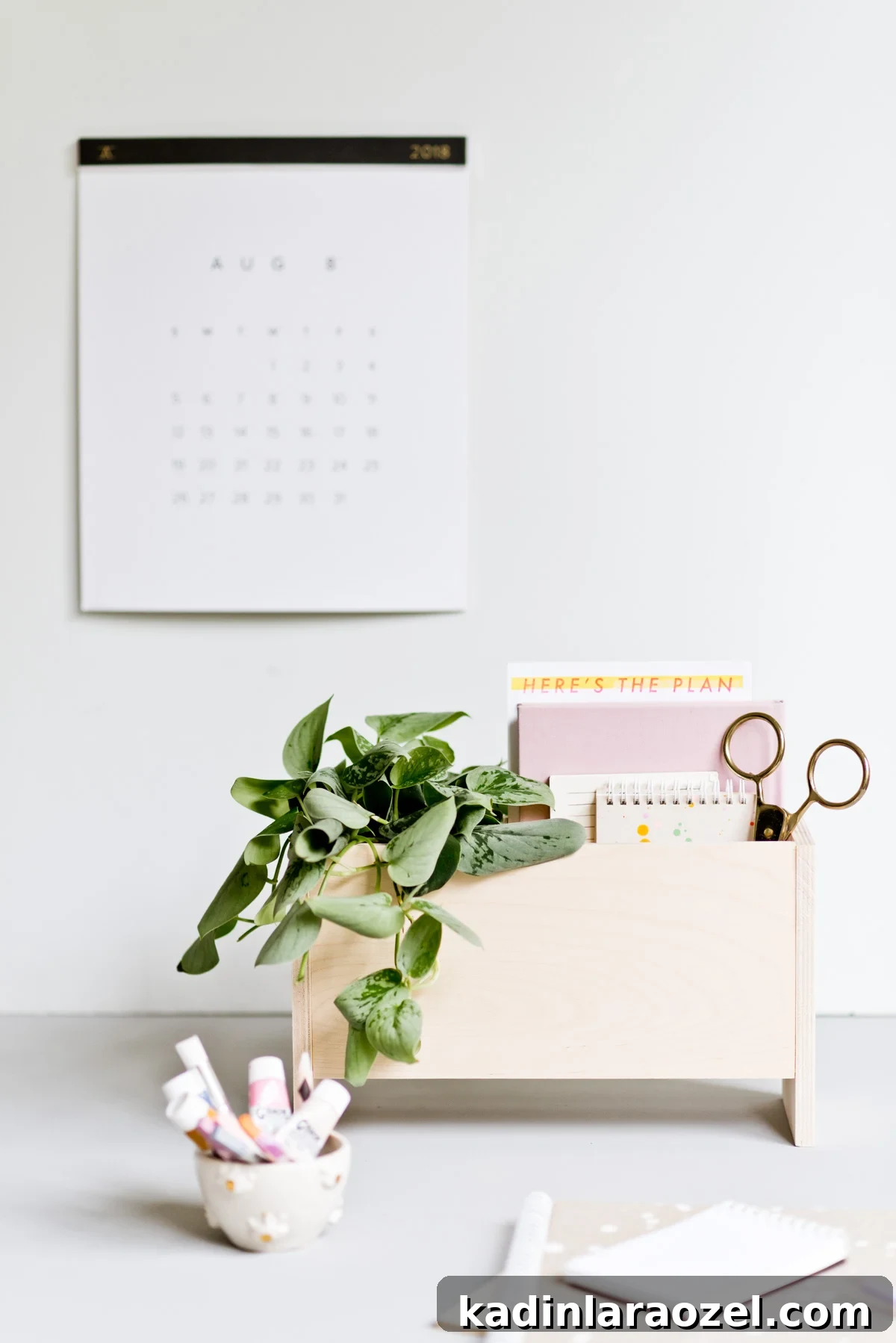 wood desk organizer with minimal modern design and plant and notebooks inside